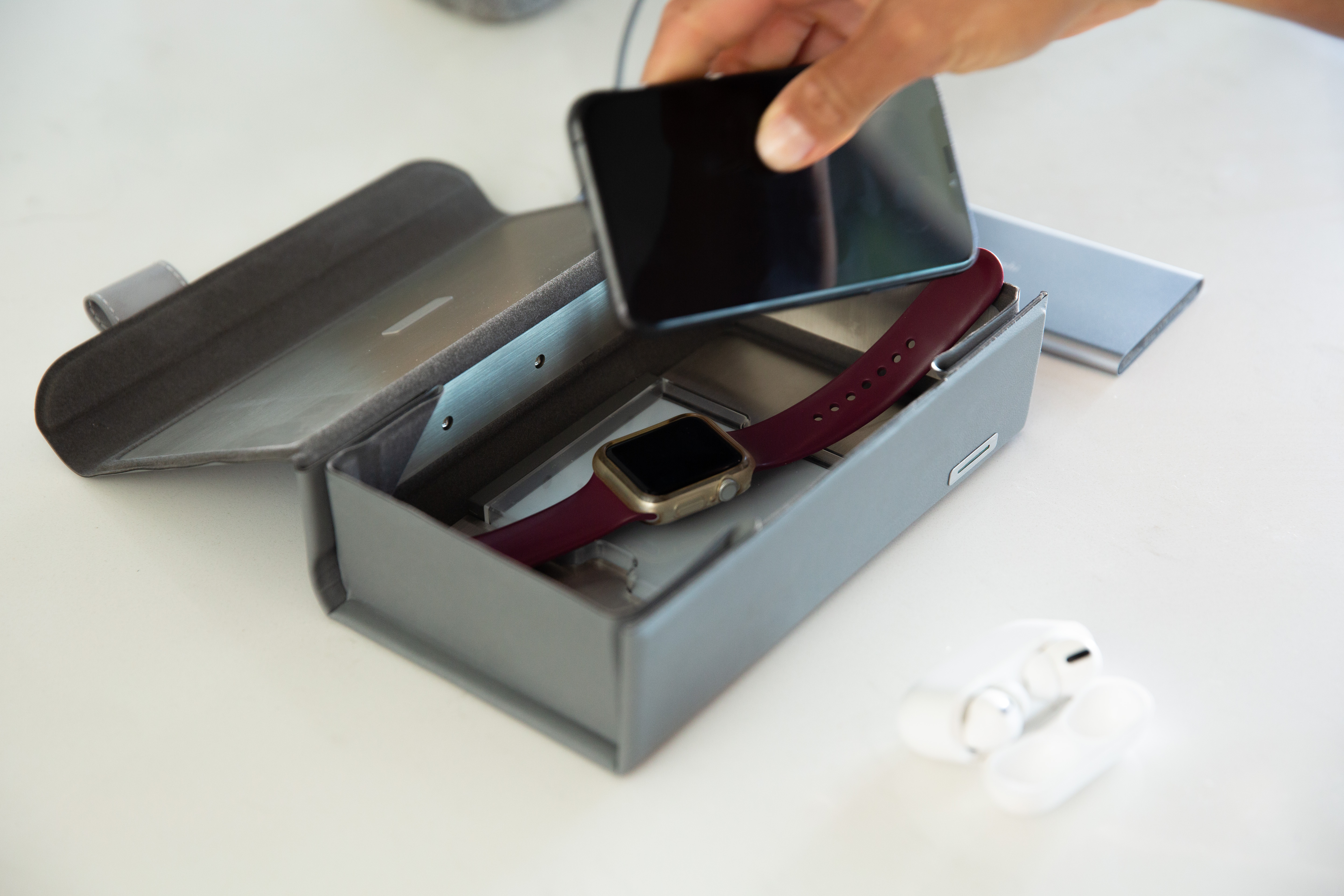 Placing a phone and Apple Watch inside Deep Purple, which is open and resting on a table